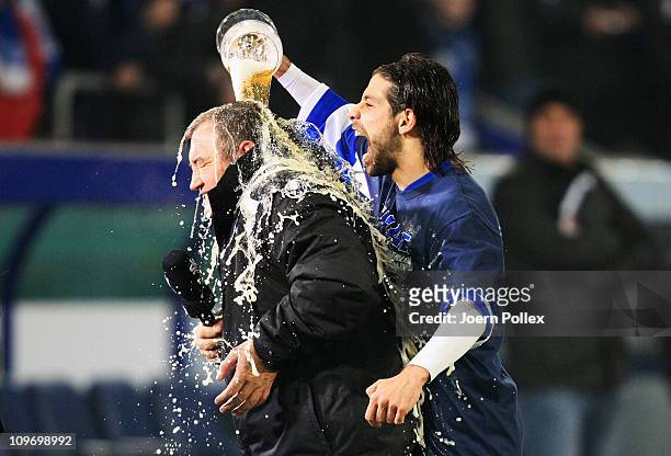 Head coach Milan Sasic of Duisburg gets a beer shower from Olcay Sahan after winning the DFB Cup semi final match beween MSV Duisburg and Energie...