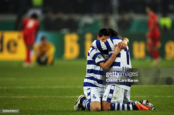 Olivier Veigneau of Duisburg celebrates with team mate Olcay Sahan after winning the DFB Cup semi final match between MSV Duisburg and Energie...