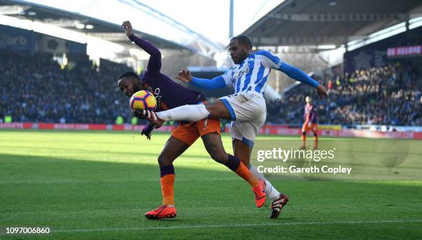 Raheem Sterling of Manchester City is tackled by Jason Puncheon of Huddersfield during the Premier League match between Huddersfield Town and...