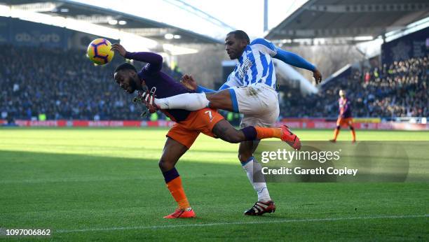 Raheem Sterling of Manchester City is tackled by Jason Puncheon of Huddersfield during the Premier League match between Huddersfield Town and...