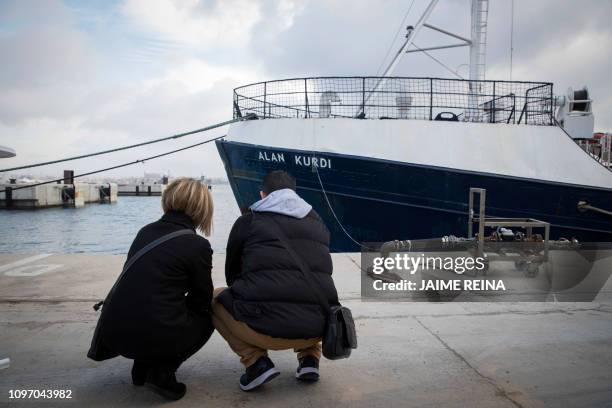 Abdullah Kurdi and his siter Tima squat in front of a Sea-Eye rescue ship named after his son and her nephew Alan Kurdi during its inauguration in...