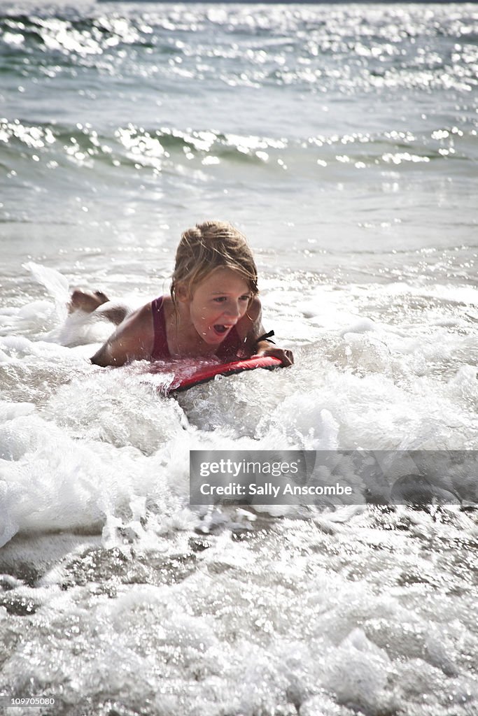 Girl body boarding in the sea