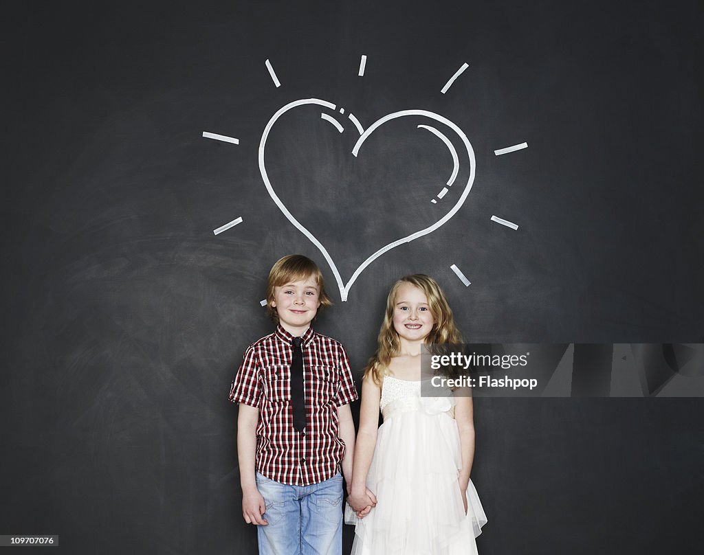 Portrait of boy and girl with love heart