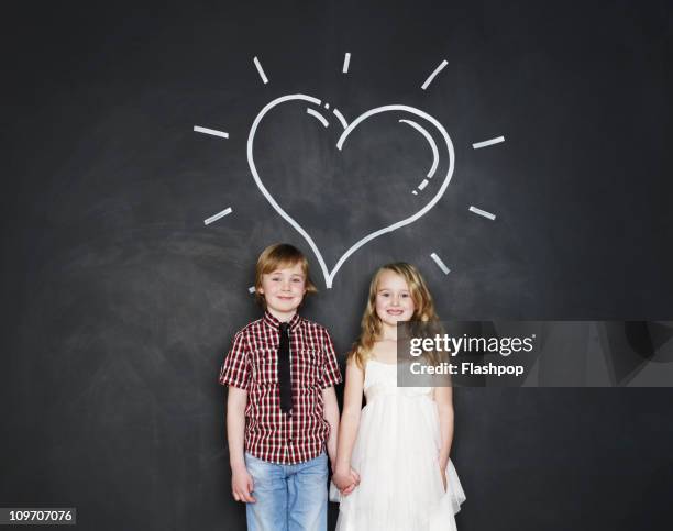 portrait of boy and girl with love heart - kid blackboard stock pictures, royalty-free photos & images