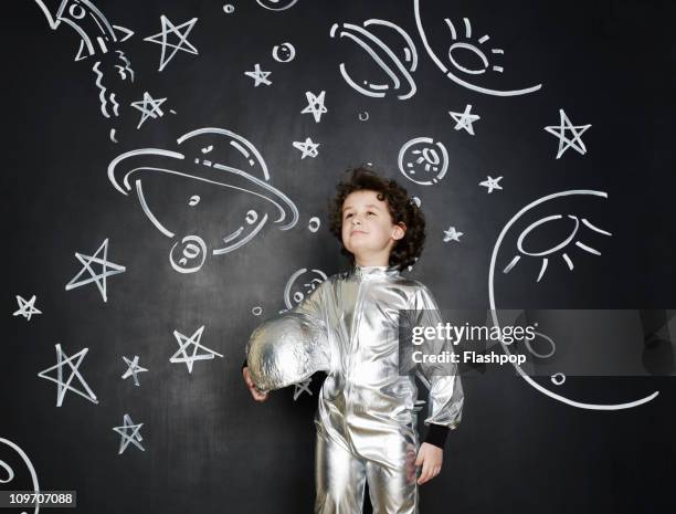 boy dressed as an astronaut - space helmet stock-fotos und bilder