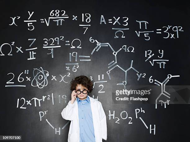 boy as a professor with formulas behind him - inteligencia fotografías e imágenes de stock