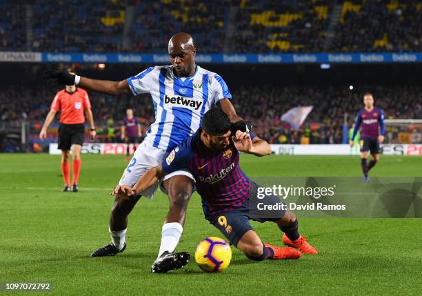 Luis Suarez of Barcelona is challenged by Allan-Romeo Nyom of Leganes during the La Liga match between FC Barcelona and CD Leganes at Camp Nou on...