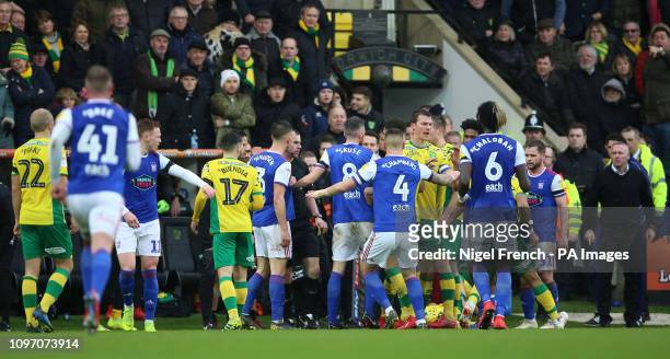 Norwich City's and Ipswich Town's players confront each other before half time leading to Ipswich Town manager Paul Lambert receiving a red card...