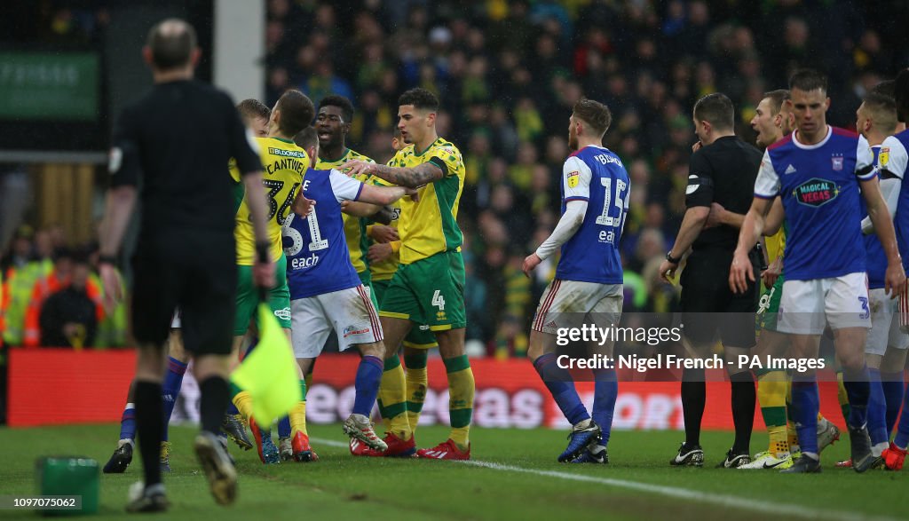 Norwich City's and Ipswich Town's players confront each other in the