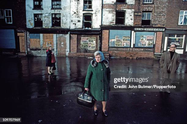 Two women and a man on a run-down street in Manchester, England in 1976.