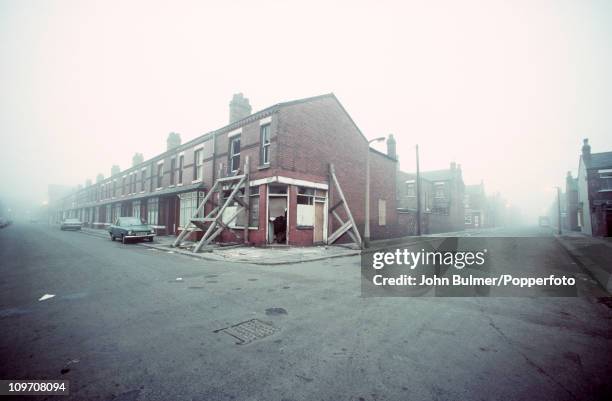 Derelict end-of-terrace house propped up to prevent its collapse, Manchester, England 1976.