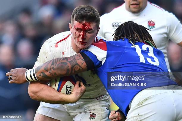 England's flanker Tom Curry is tackled by France's centre Mathieu Bastareaud during the Six Nations international rugby union match between England...