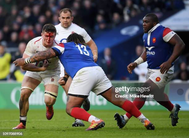 Bloody Tom Curry of England is tackled by Mathieu Bastareaud of France during the Guinness Six Nations match between England and France at Twickenham...