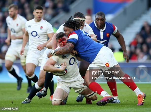 Bloody Tom Curry of England is tackled by Mathieu Bastareaud of France during the Guinness Six Nations match between England and France at Twickenham...