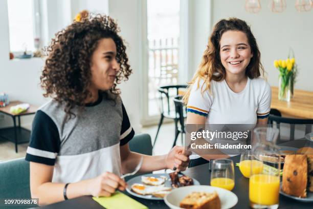 teenagers having breakfast - teenager eating stock pictures, royalty-free photos & images