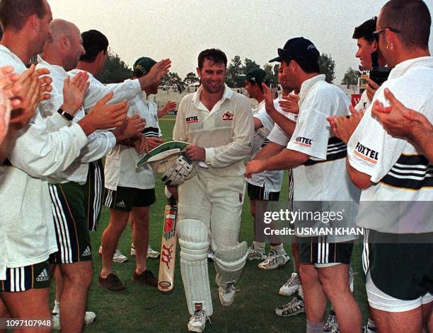 Australian skipper Mark Taylor is warmly received by his teammates after his unbeaten 334-run effort on the 2nd day of the 2nd cricket Test against...