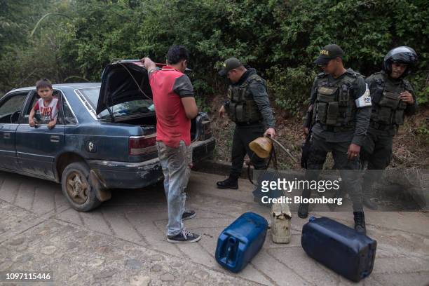 Fiscal and Customs Police officers inspect a vehicle carrying fuel canisters near Cucuta, Colombia, on Saturday, Feb. 9, 2019. In Caracas,...