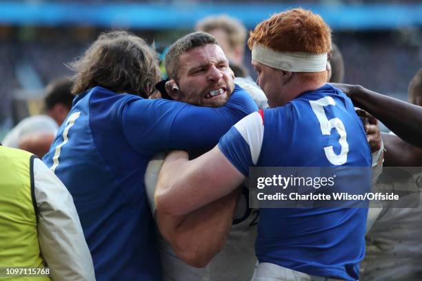 Furious Mark Wilson of England is held in a headlock as a fight breaks out during the Guinness Six Nations match between England and France at...