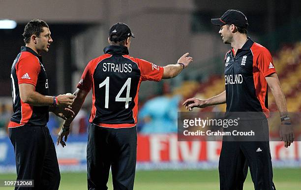 Captain Andrew Strauss of England gestures to his strike bowlers Tim Bresnan and James Anderson in the Group B 2011 ICC World Cup match between...