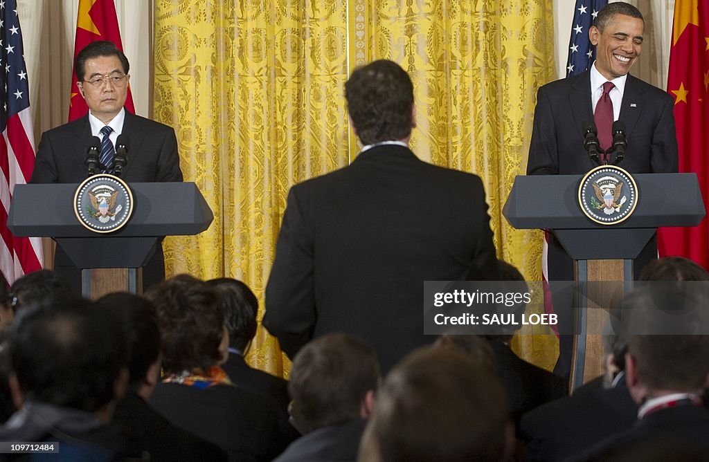 US President Barack Obama listens to a q