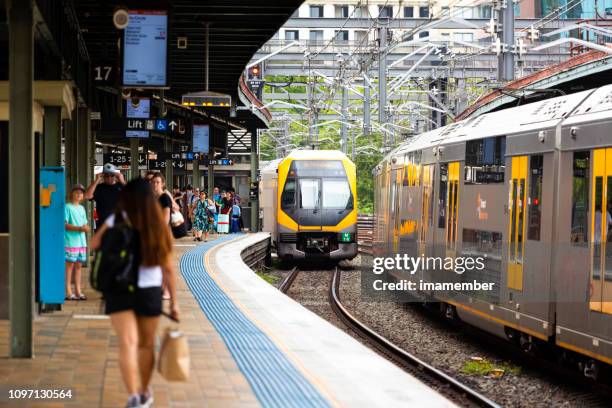 train staion with passengers and trains getting in and out of the train staion - public transport stock pictures, royalty-free photos & images