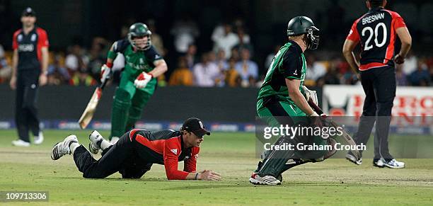 Ian Bell of England attempts a run out Kevin O'Brien of Ireland in the Group B 2011 ICC World Cup match between England and Ireland at M. Chinnaswamy...
