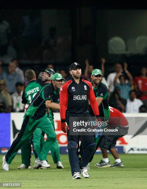 Matt Prior of England looks dejected as Ireland players celebrate the defeat of England in the Group B 2011 ICC World Cup match between England and...