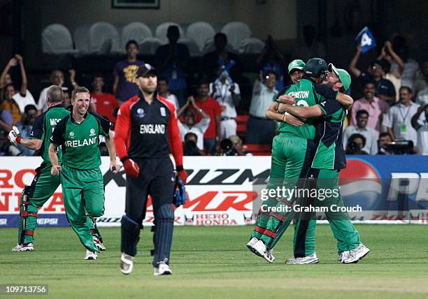 Matt Prior of England looks dejected as Ireland players celebrate the defeat of England in the Group B 2011 ICC World Cup match between England and...