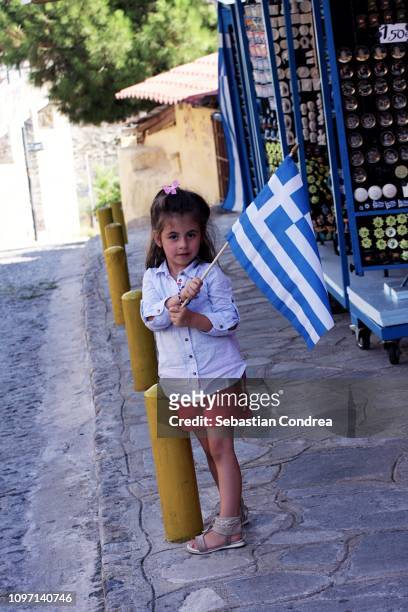 girl with the greece flag on a fortress wall, discovering greece - citadel military college stock pictures, royalty-free photos & images