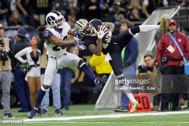 Ted Ginn of the New Orleans Saints makes a 43-yard catch against Lamarcus Joyner of the Los Angeles Rams in the fourth quarter in the NFC...
