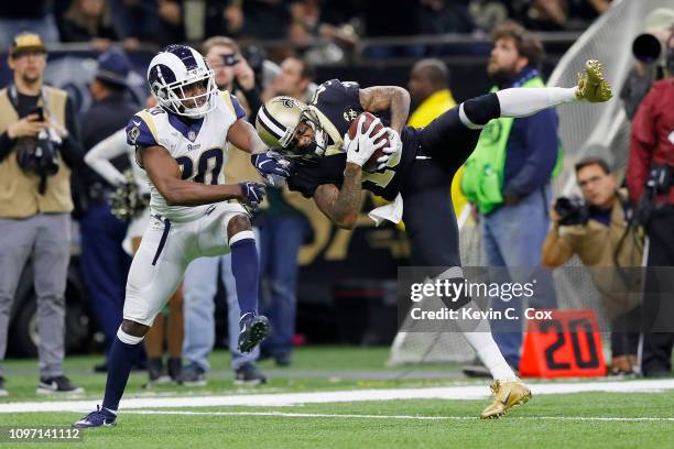 Ted Ginn of the New Orleans Saints makes a 43-yard catch against Lamarcus Joyner of the Los Angeles Rams in the fourth quarter in the NFC...