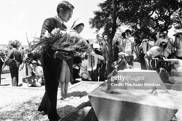 Crown Prince Akihito and Crown Princess Michiko offer flowers at Konpaku-no-To on July 17, 1975 in Itoman, Okinawa, Japan.