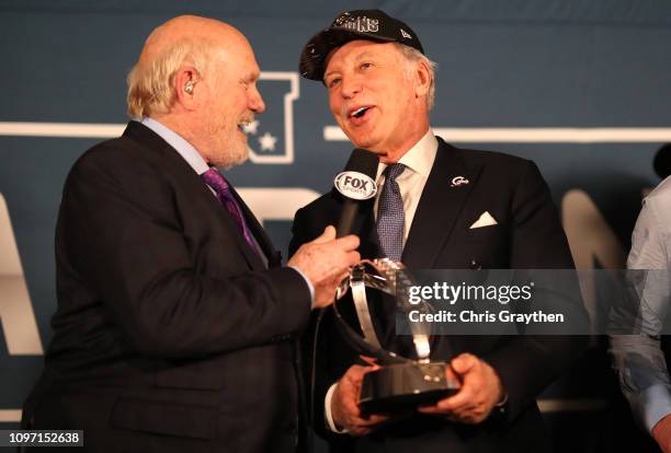 Terry Bradshaw presents Stanley Kroenke, owner of the Los Angeles Rams the NFC Championship trophy after defeating the New Orleans Saints in the NFC...