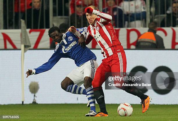 Arjen Robben of Bayern Muenchen fights for the ball with Anthony Annan of Schalke during the DFB Cup semi final match between FC Bayern Muenchen and...