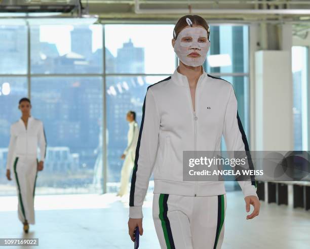 Model wears a face mask as she walks the runway during rehearsal for the Tory Burch Fall/Winter 2019 fashion show during New York Fashion Week at...