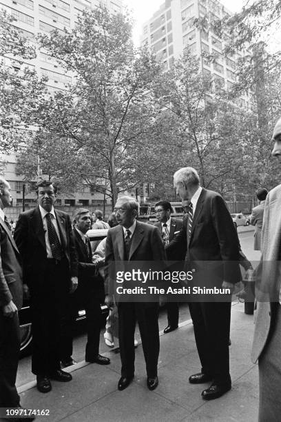 Emperor Hirohito is welcomed by John D. Rockefeller III on arrival at the Japan House on October 6, 1975 in New York City.