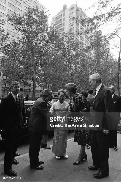Emperor Hirohito and Empress Nagako are welcomed by John D. Rockefeller III and his wife Blanchette on arrival at the Japan House on October 6, 1975...