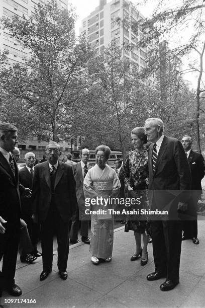 Emperor Hirohito and Empress Nagako are welcomed by John D. Rockefeller III and his wife Blanchette on arrival at the Japan House on October 6, 1975...