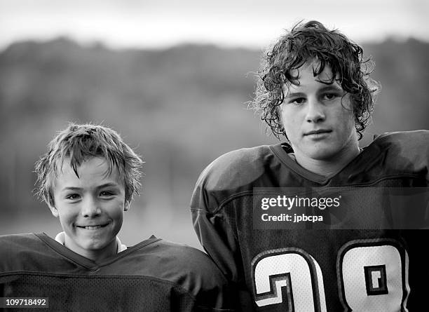 two boys wearing football jerseys - football player face stock pictures, royalty-free photos & images