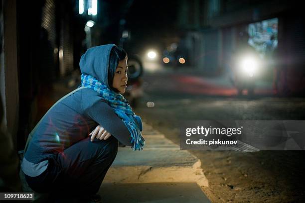 asian woman sitting on street at night - homeless youth stock pictures, royalty-free photos & images