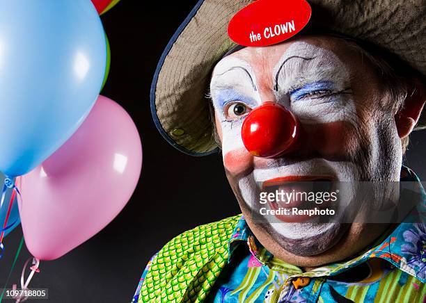colorful clown winking at the camera - a fool stock pictures, royalty-free photos & images