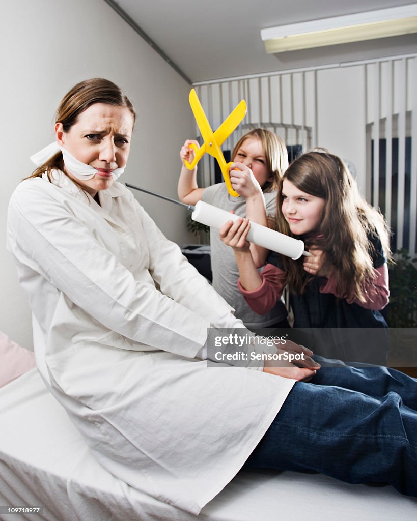 Children Tying up Doctor