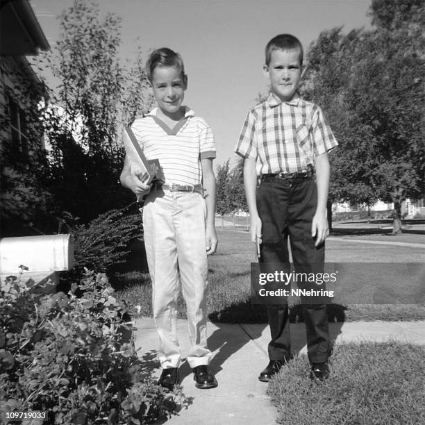 two children ready for school 1959, retro - only boys photos stockfoto's en -beelden