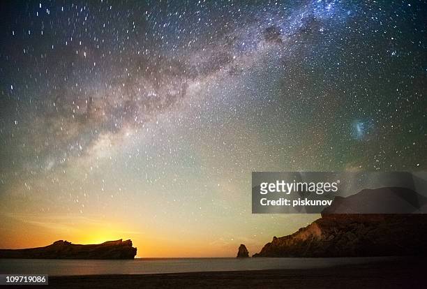 stars at dusk over beach - timelapse new zealand stock pictures, royalty-free photos & images
