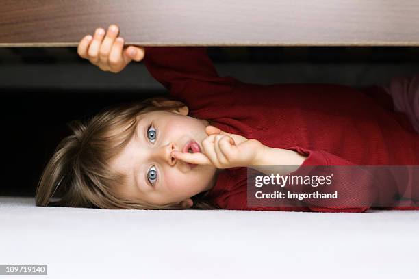 hiding under a bed - hidw and seek stock pictures, royalty-free photos & images