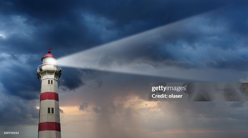 Partly sunlit lighthouse, bad weather in background