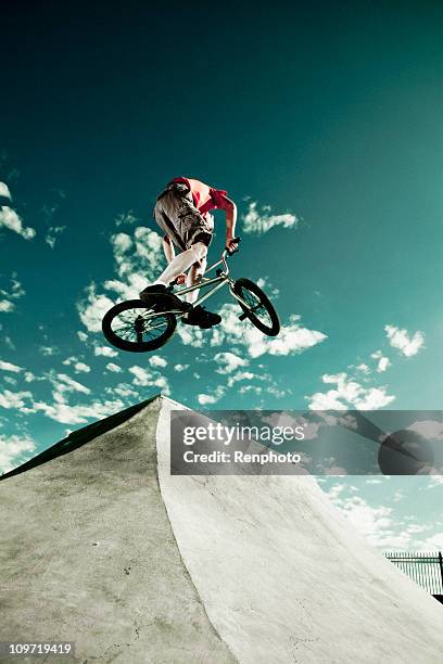 biker jumping at a skate park - bmx park stock pictures, royalty-free photos & images