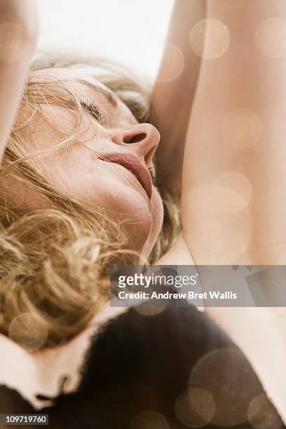 woman in lingerie, arms raised, in ecstasy - ecstatic woman stock pictures, royalty-free photos & images