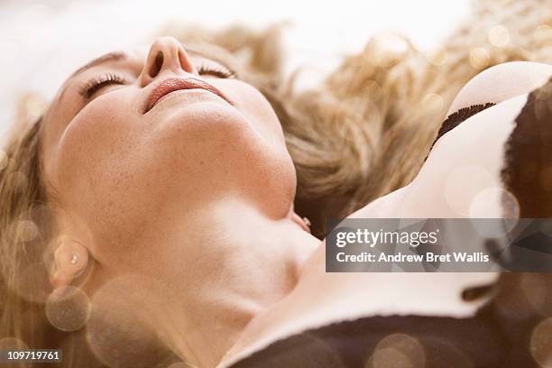 woman in lingerie resting with eyes closed - 性的行動 ストックフォ��トと画像