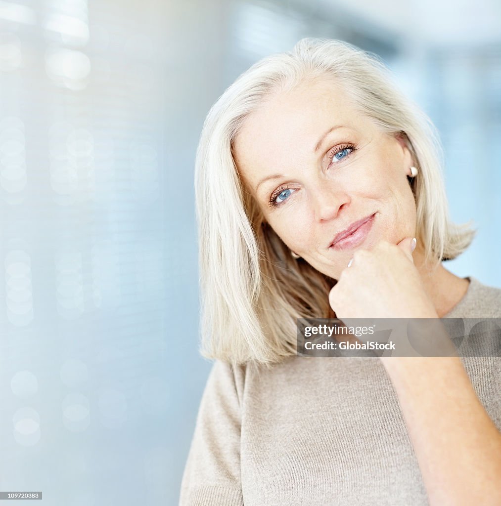 Portrait of a beautiful mature woman with hand on chin